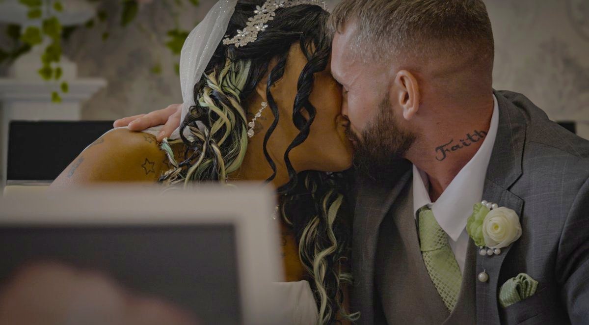 The couple sharing a kiss